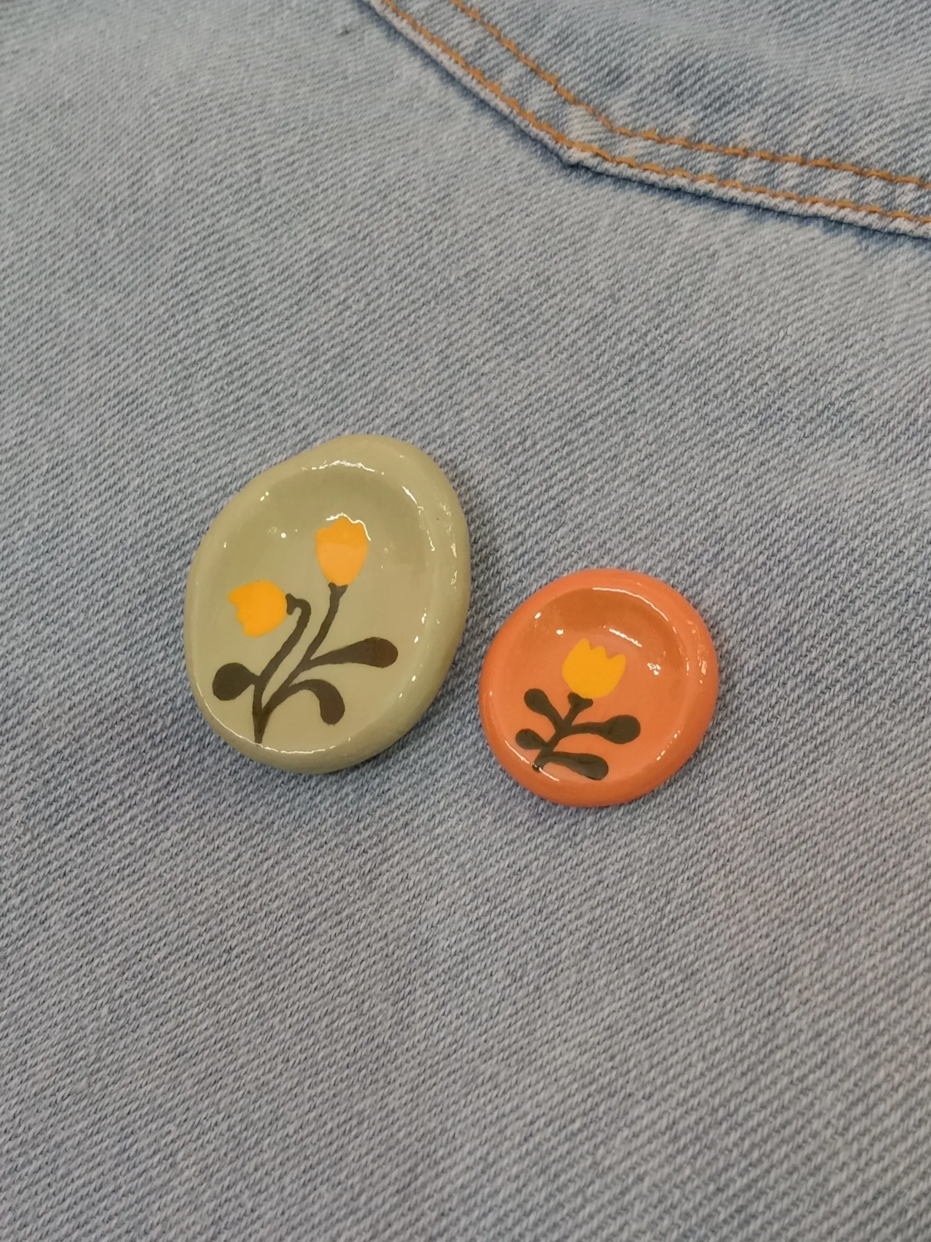 Different angles highlighting the premium glossy glaze finish over the hand-painted details on a clay stress stone.